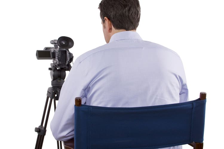 casting director sitting and recording auditions with camera