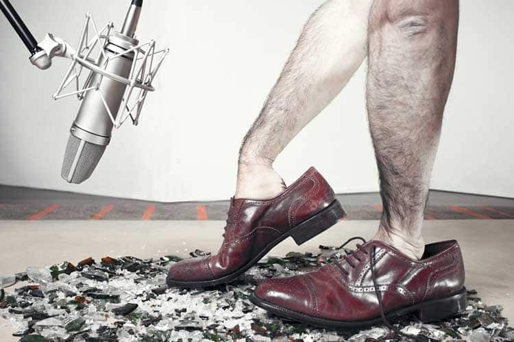Foley man steps with soundman hands inside the dress shoes