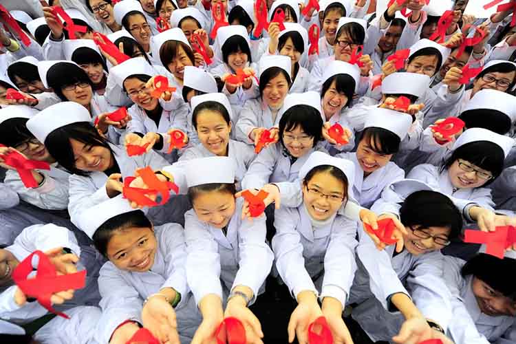 Chinese nursing students hold red ribbons